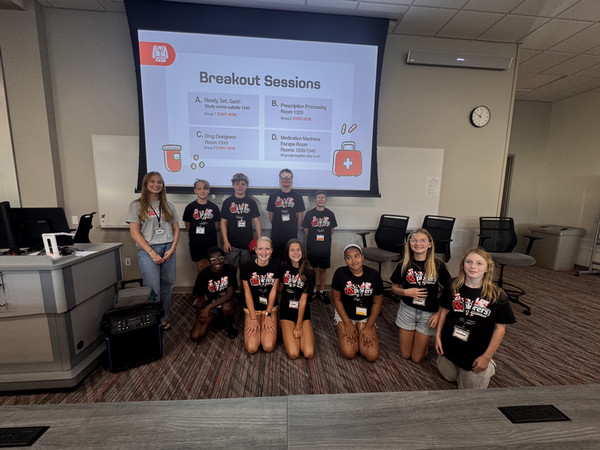 Students in Rxplorers camp pose in front of projection screen