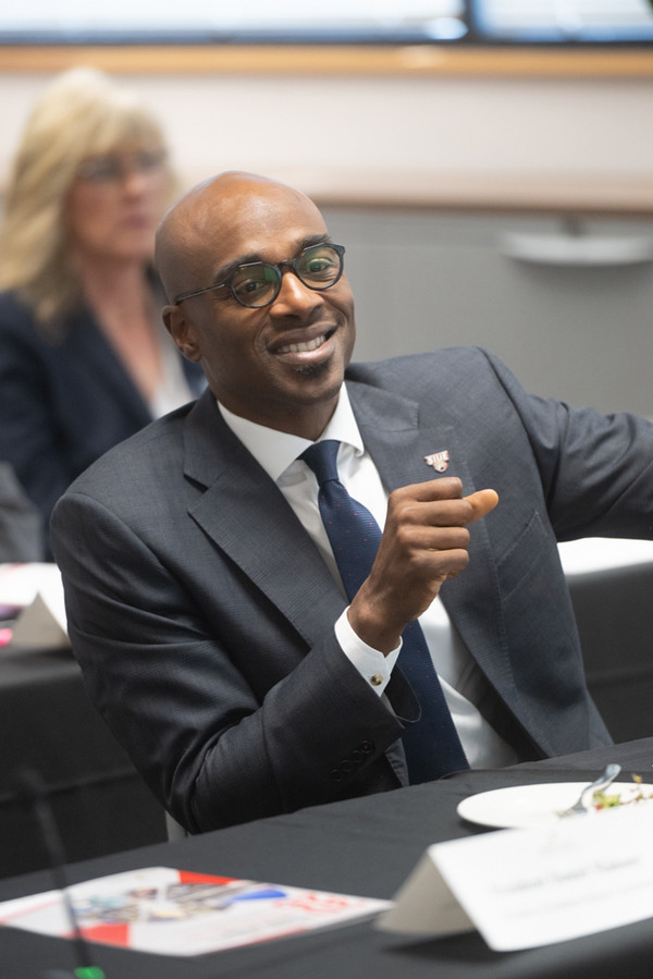 Dr Minor smiling while seated at table at NCERC meeting