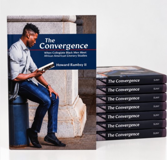 A book mockup with a young man reading the book and sitting on and near a stack of books titled The Convergence