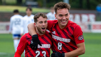 Two SIUE men's soccer players celebrate a great play.