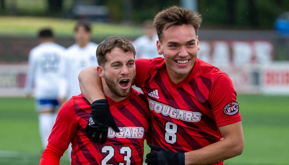 Two SIUE men's soccer players celebrate a great play.