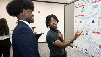 Two SIUE student talk about a display.