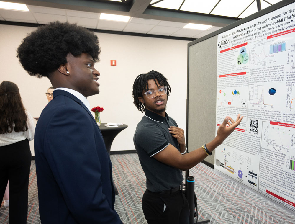 Two SIUE student talk about a display.